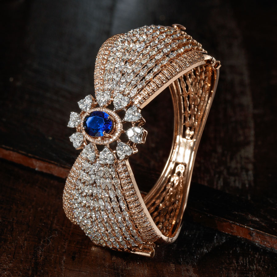 Rose Gold and Diamond with Sapphire Bracelet on a brown wooden background