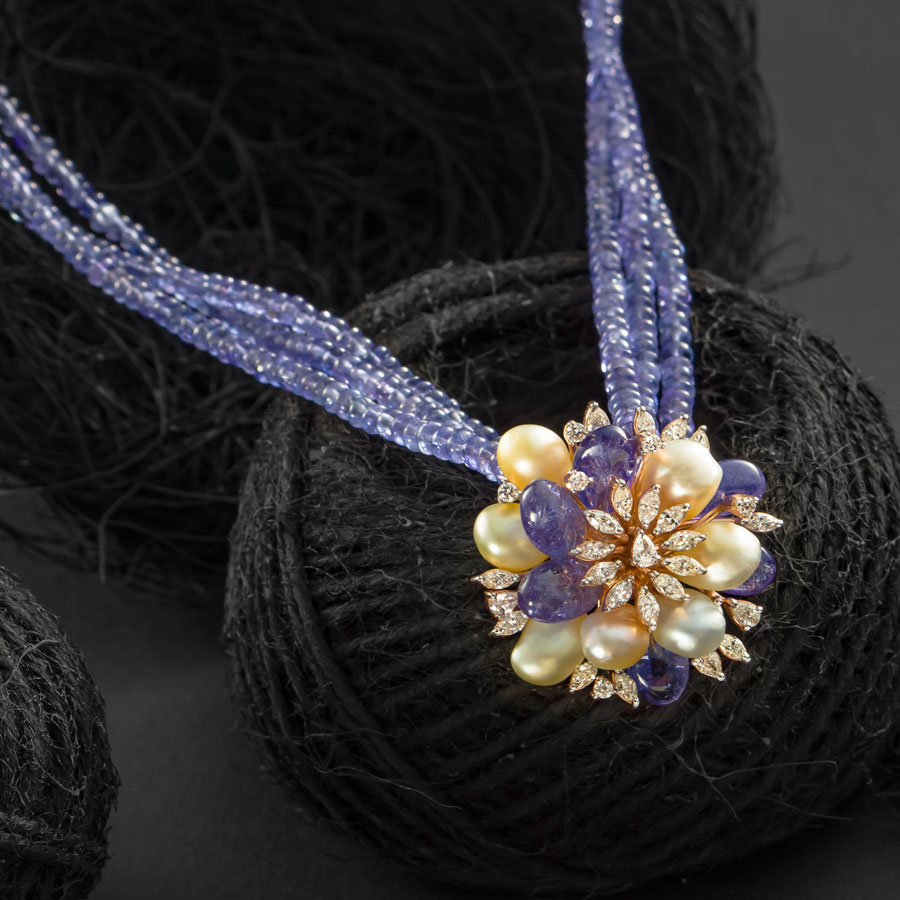 Diamond and Pearls Necklace placed on a black backdrop