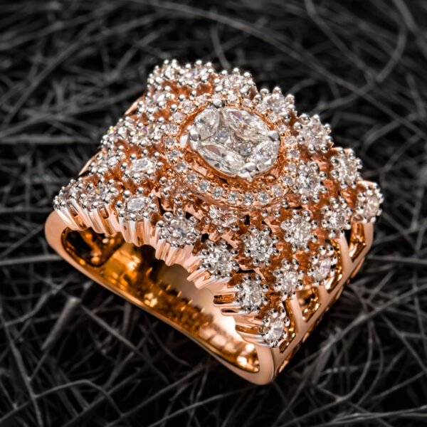 Curled Rose Gold and Diamond Ring on a dark background