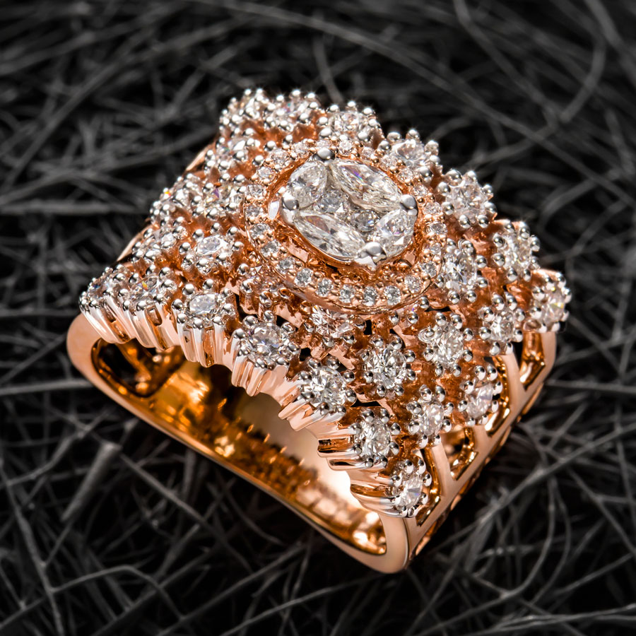 Curled Rose Gold and Diamond Ring on a dark background