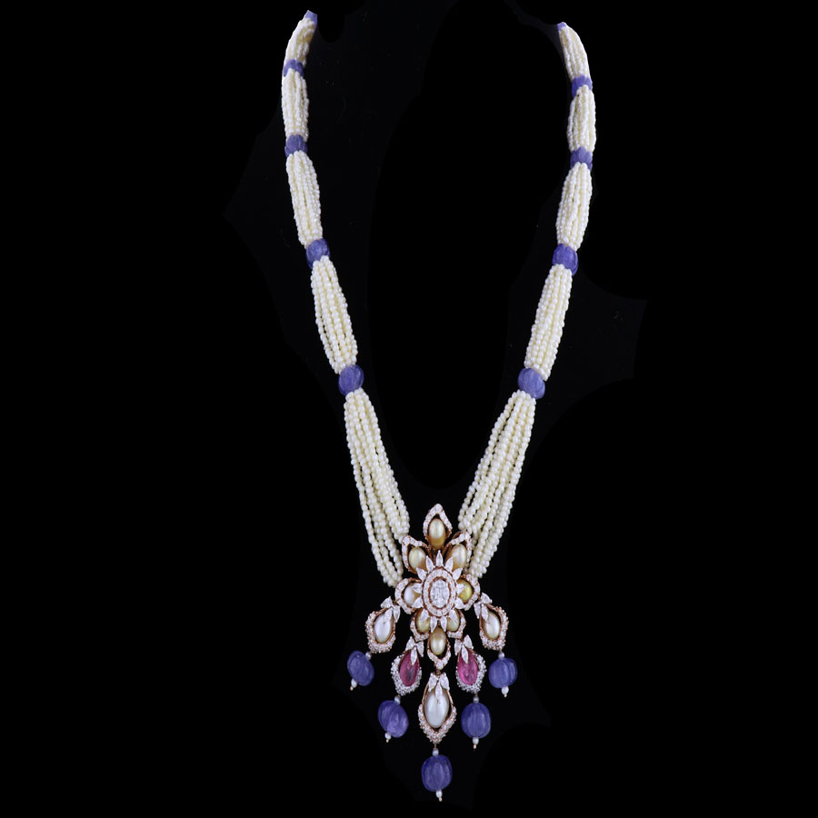 White and Purple Floral Pearls and Diamond Pendant on a black background