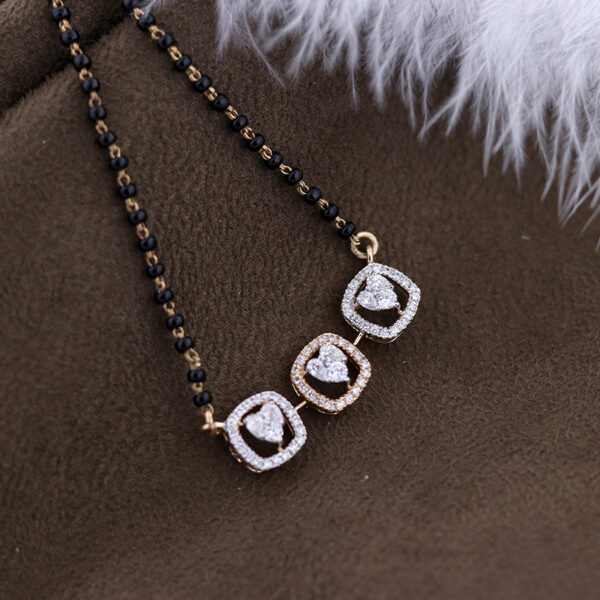 heart shaped diamond troika pendant on a black beads chain and dark background